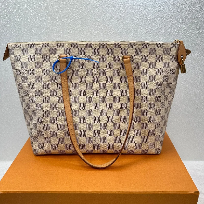 Louis Vuitton tote bags with a printed LV logo on the front for brand visibilityHandbag Designer By Louis Vuitton  Size: Large